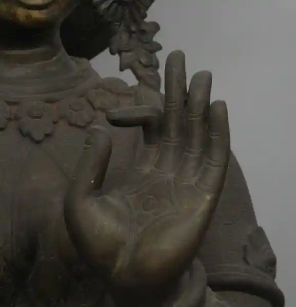 Bronze statue of Laxmi, four-point symbol, cross on the hand